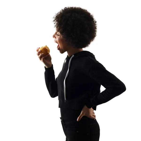 Young teenager girl woman eating apple shadow silhouette isolate — Stock Photo, Image