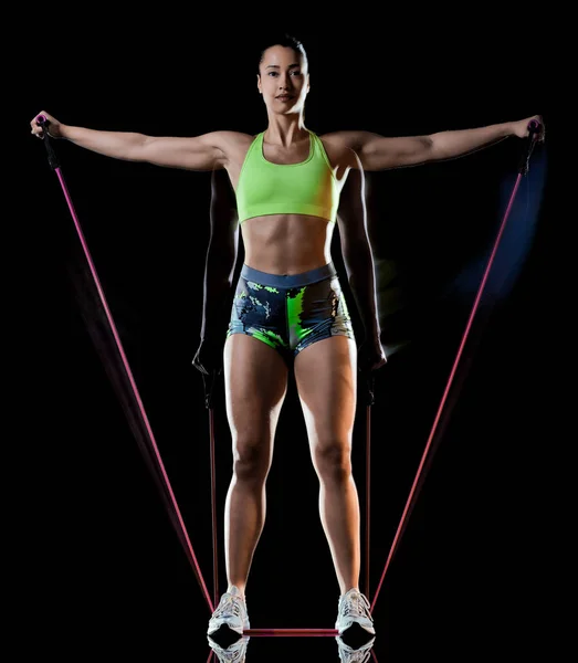 Mujer ejercitando ejercicios de fitness aislado fondo negro efecto lightpainting —  Fotos de Stock