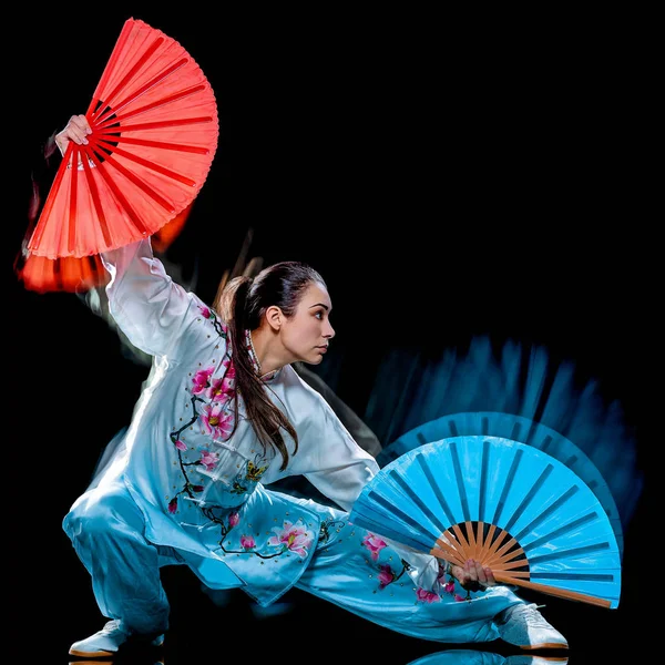 Woman Tai Chi Chuan Tadjiquan posture isolated black background light painting — Stock Photo, Image