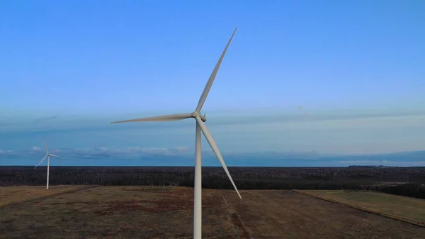 Wind turbine from aerial view - Sustainable development, environment friendly, renewable energy concept. Aerial View Of Wind Turbines In Blue Sky.