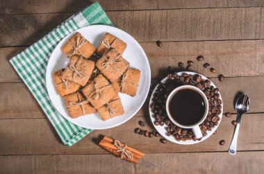 Yeşil bir peçete ve ev yapımı kurabiye beyaz bir fincan sade kahve.