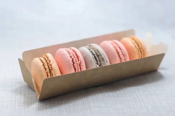 Appetizing cakes macaroons in the package close up