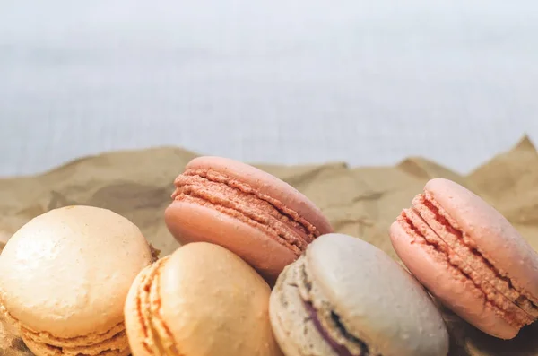 Appetizing cakes macaroons in the package close up