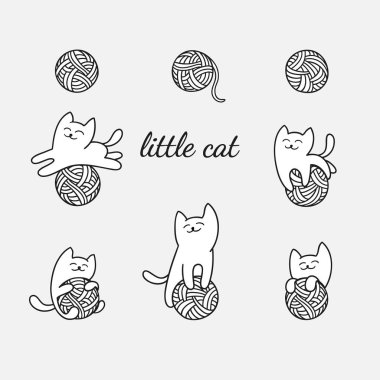 beyaz kedi yün topları ile oynuyor.