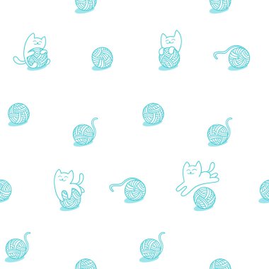 Küçük kediler yün topları ile oynuyor.