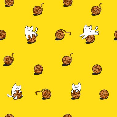 beyaz kedi yün topları ile oynuyor.