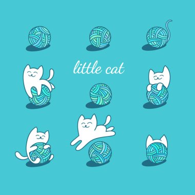 beyaz kedi yün topları ile oynuyor.