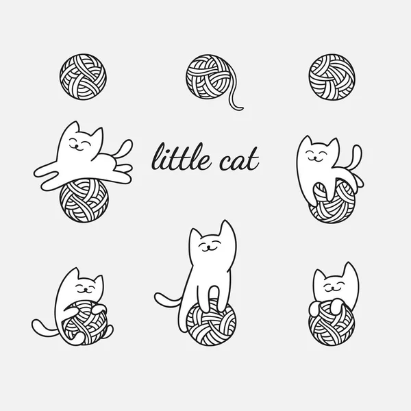 beyaz kedi yün topları ile oynuyor.