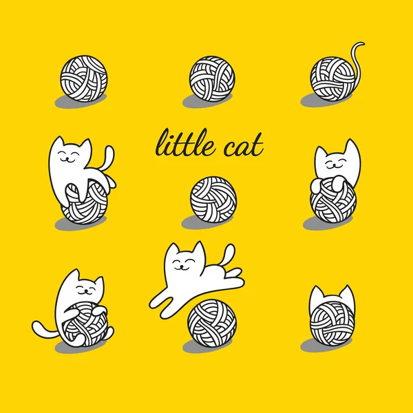 beyaz kedi yün topları ile oynuyor.