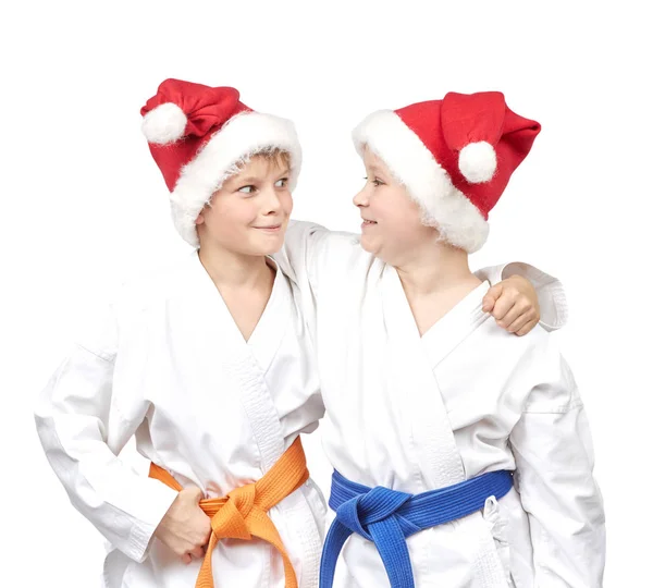 Sportsmen in karategi and Santa Claus caps — Stock Photo, Image