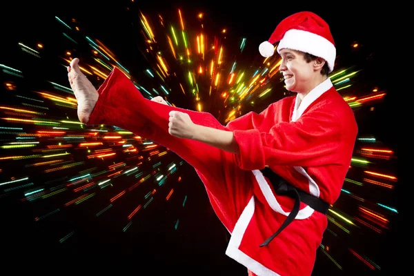 Woman dressed as Santa Claus hits a kick leg — Stock Photo, Image