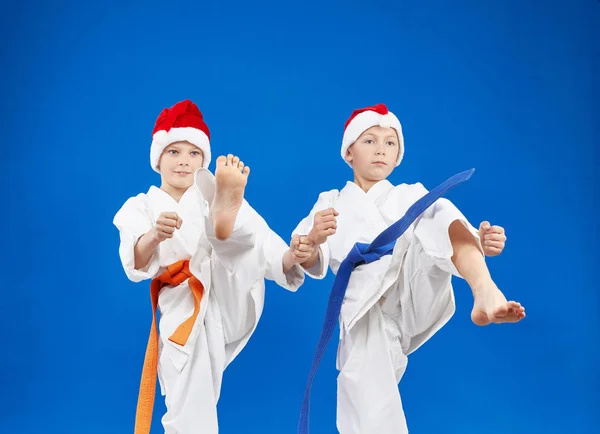 Two karateka are beating kick leg — Stock Photo, Image