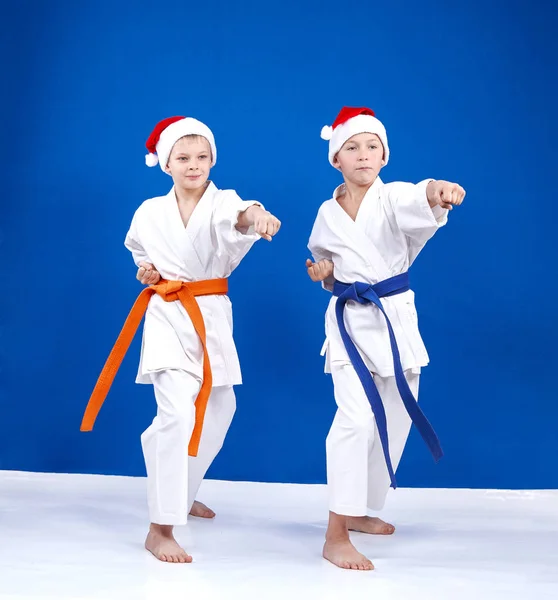 Children in the rack of karate hit punch arm — Stock Photo, Image