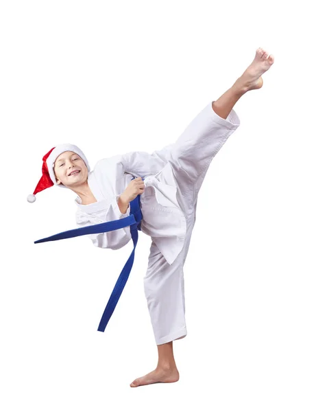 Спортсмен в шапке Санта-Клауса бьет по ноге — стоковое фото