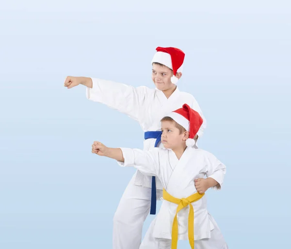 With blue and yellow belt the boys are beating punch arm — Stock Photo, Image