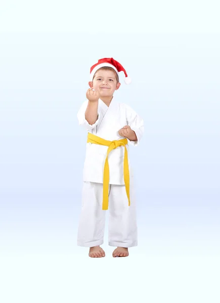 Lilla karateka i en mössa av jultomten är i rack karate — Stockfoto