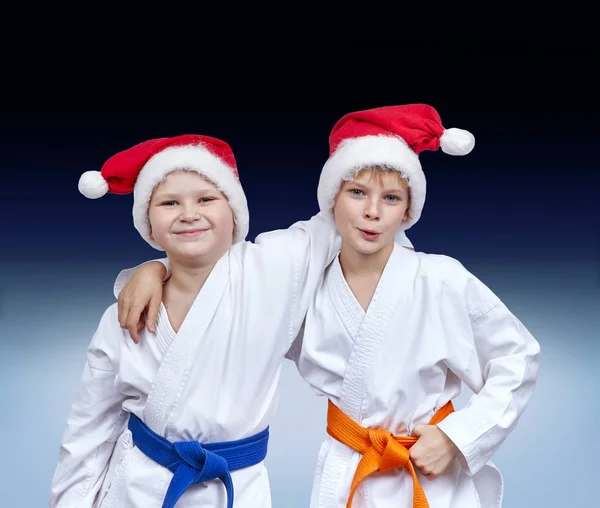 Jungen in Mützen des Weihnachtsmannes auf einem Gradientenhintergrund — Stockfoto
