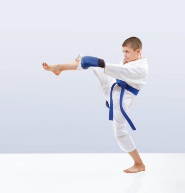 Boy with blue belt and overlays on the hands is beating kicking clipart
