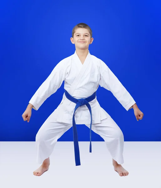 Athlete with a blue belt is in the rack karate — Stock Photo, Image