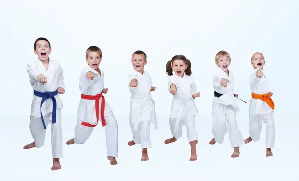 On a light background six karateka beating punch arm — Stock Photo, Image