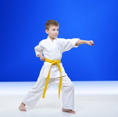 Açık mavi renkli atlet yumruk kol atıyor.