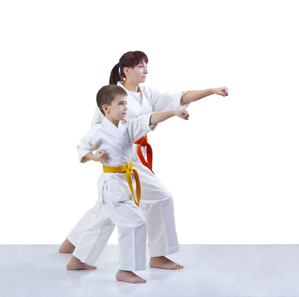 With yellow and orange belt the mother and son are hitting a punch arm — Stock Photo, Image