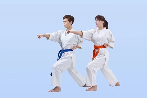 With blue and orange belt athletes train punch arm