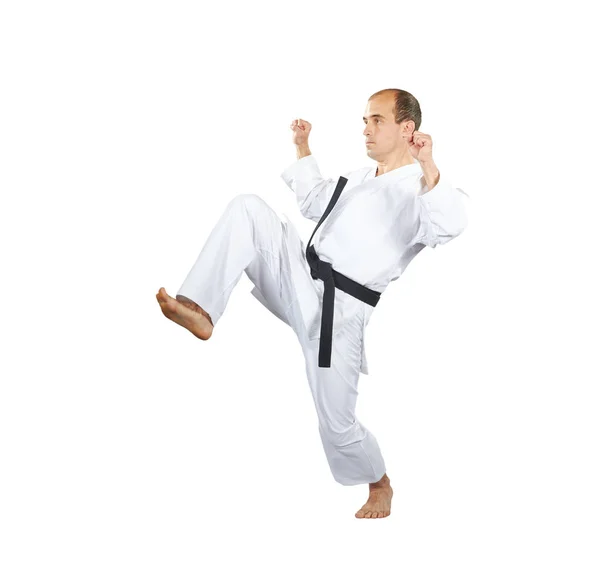 Blokkolja a kezét és lábát rúgást csinál egy sportoló karategi — Stock Fotó