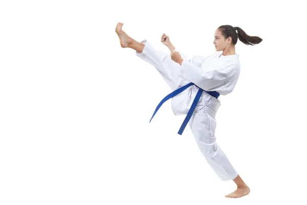 With a blue belt, the athlete beats the kick forward — Stock Photo, Image