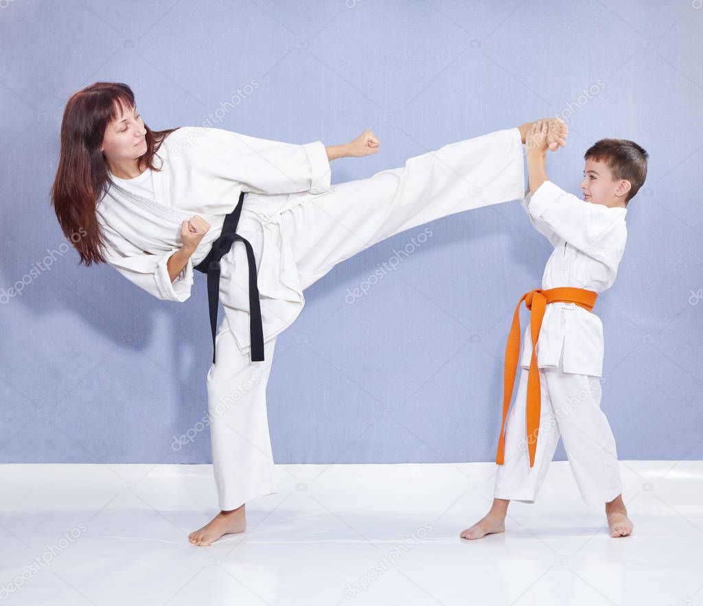 Mother and son are training kick leg