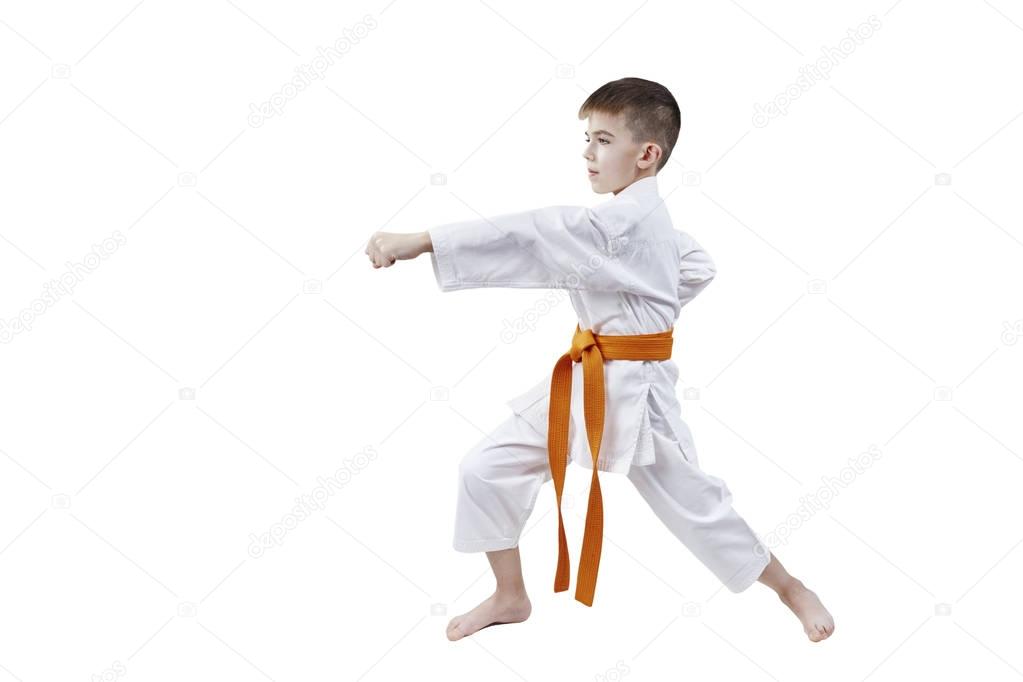 With an orange belt, a small sportsman is beating blow hand