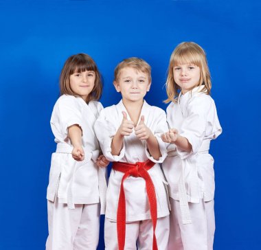 Three children standing in karate rack and showing finger super clipart