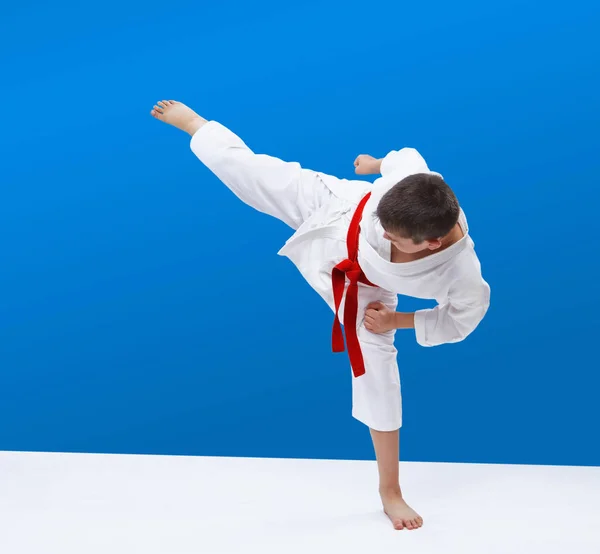 Een Blauwe Achtergrond Klopt Jongen Karate Klap Been — Stockfoto