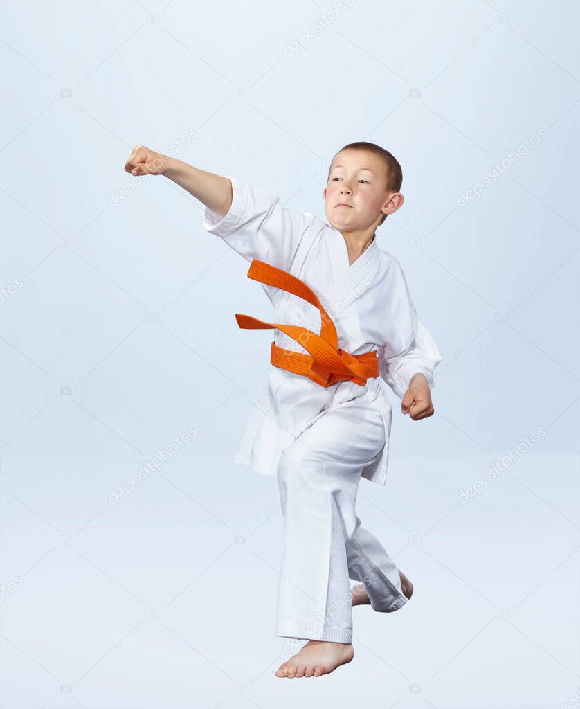 Karateka boy is beating punch arm
