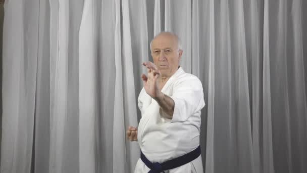 Old Male Athlete Blue Belt Trains Blocks His Hands — Stock Video