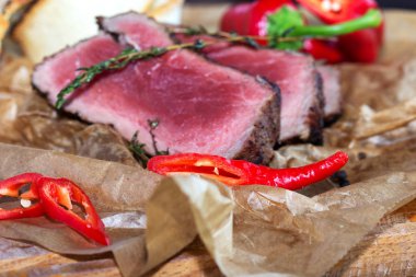 Fırında domates, sarımsak, acı biber ve biberiyeli biftek.