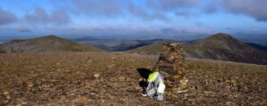 Walking pole and camera bag on the summit