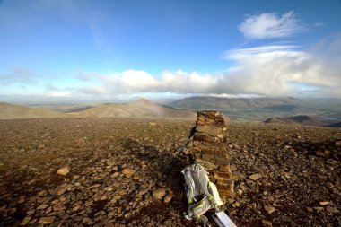 Walking pole and camera bag on the summit
