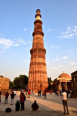 Old Delhi, India - 6th November 2019:Tourist in the evening sunlight in the Qutb Minar Tower