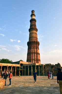 Old Delhi, India - 6th November 2019:Tourist in the evening sunlight in the Qutb Minar Tower