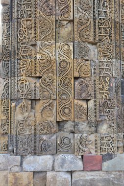 Old Delhi, India - 6th November 2019:Ornate cravings on a stone column in the Qutb Minar Tower