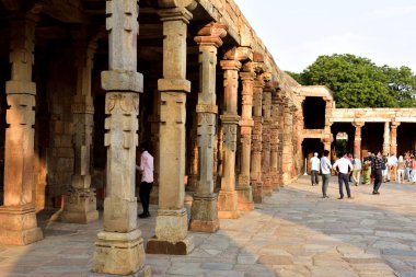 Old Delhi, India - 6th November 2019:Tourist enjoying the evening sun at the Qutb Minar Tower
