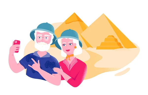 Senior couple in safari hats is taking selfie near the Egyptian pyramids. Active leisure for older people. — 스톡 벡터