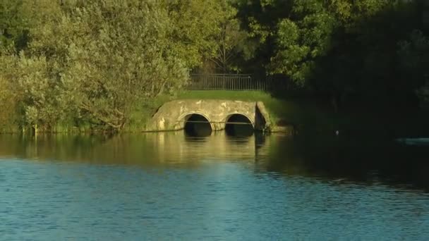 Stone bridge across the pond — Stock Video