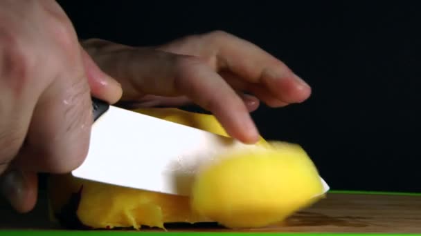 Hands Cutting Mango on black background — Stock Video