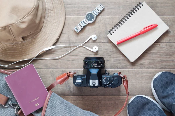 Flat lay of travel items and accessories with camera, earphones