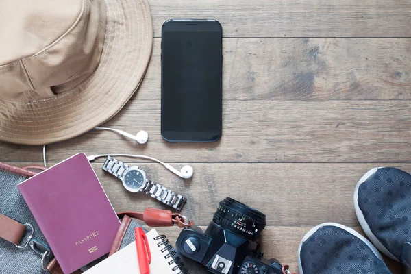 Overhead shot of travel items and accessories with mobile device