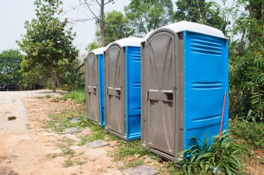 Blue Port Potties or Portable Toilets in nature public park