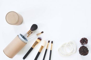 Fırçaların kopya alanı beyaz zemin üzerine inci bilezik ile düz lay