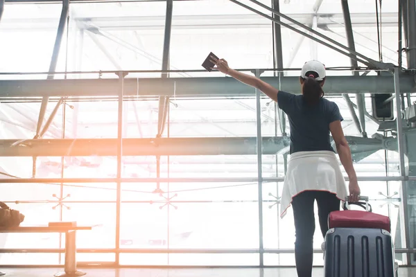 Glücklich asiatische junge Frau mit Koffer Hände nach oben auf dem Flughafen — Stockfoto